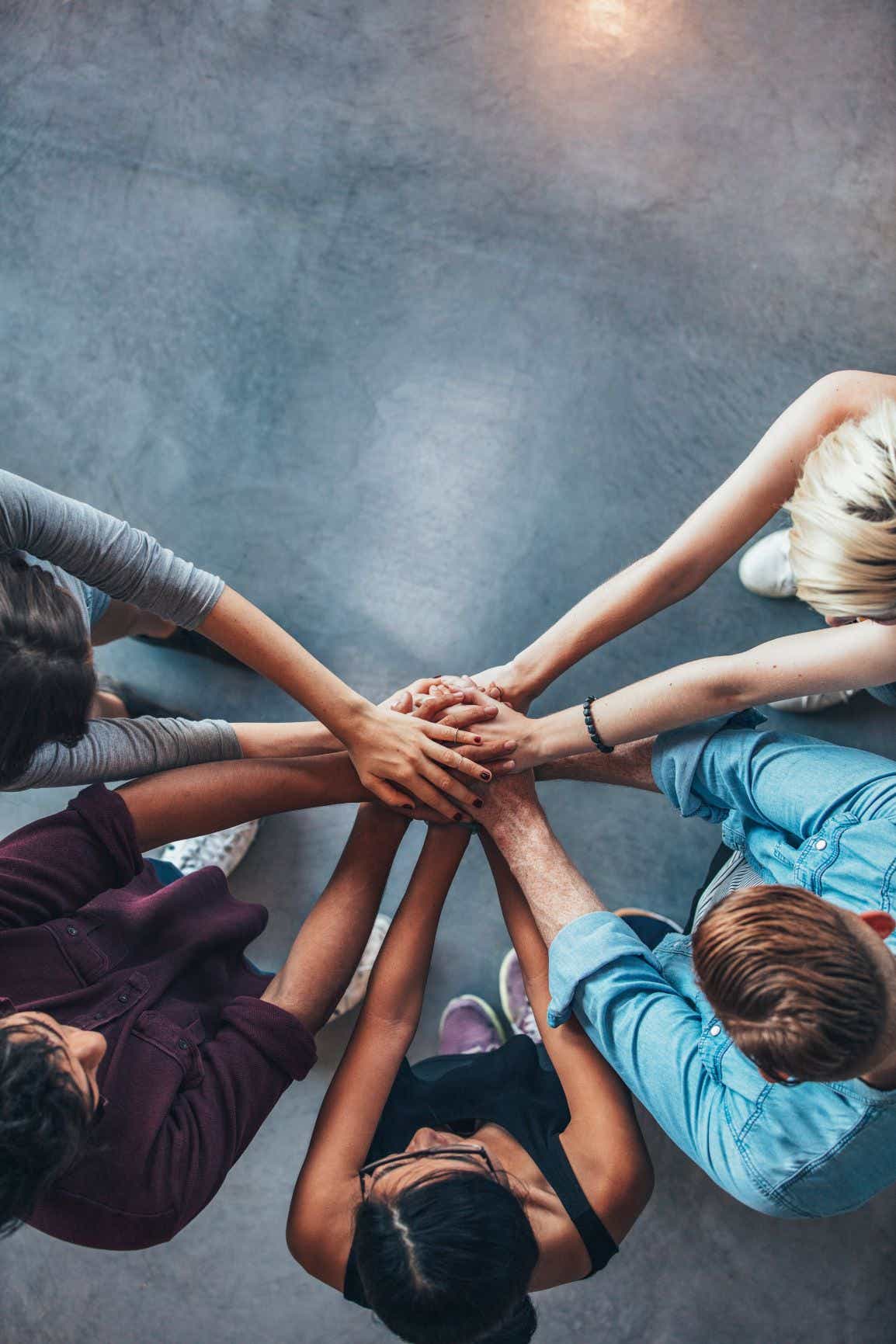 a group of students holding hands